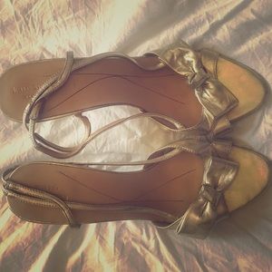 Kate Spade gold sling backs with bow.